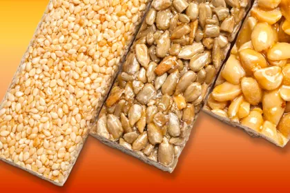 3 granola and nut bars on orange background