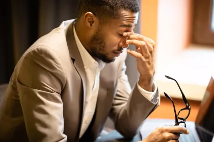 Man holding bridge of nose