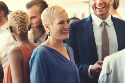crowd of people talking and smiling