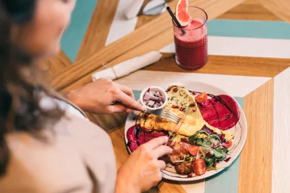 woman eating off full plate of food