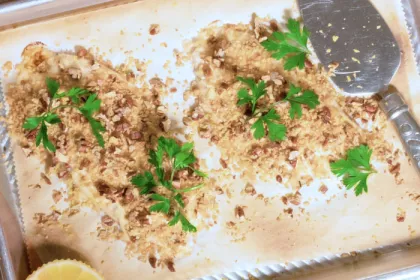 Tray with 2 filets of crunchy pecan tilapia with garnishes 