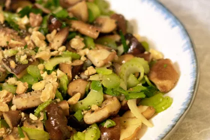 half a plate of crunchy mushroom salad on a white plate