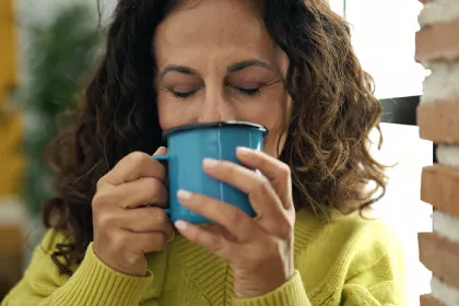 woman sipping from coffee mug