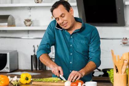 man chopping vegetables in a kitchen