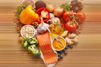 vegetables laid in a heart shape on wood background