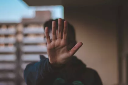 Man holding his hand up to signify "pause" or "stop"