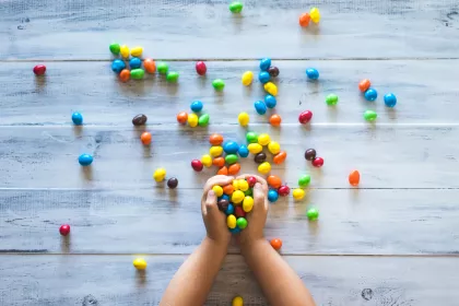 Child's hands overflowing with M&Ms