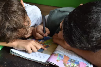 Two young classmates doing schoolwork