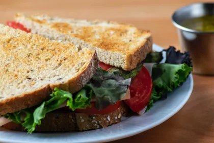 A sliced chicken and vegetable sandwich served at a restaurant