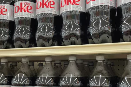 gricery store selves filled with 2 liter bottles of diet coke