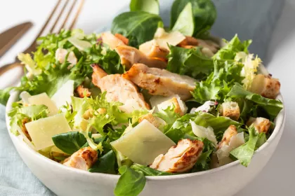 white bowl filled with chicken caesar salad