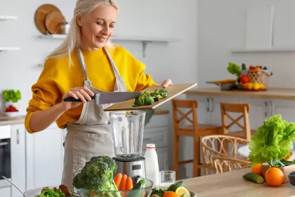 woman blending and chopping vegetables