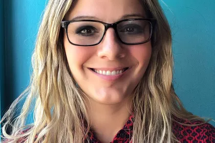 MM Bailey in a red shirt with a blue background