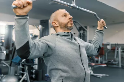man doing pull ups in a gym