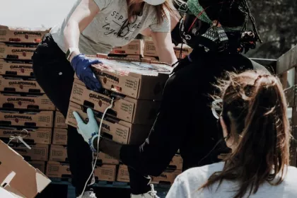 Food service workers unload crates of food
