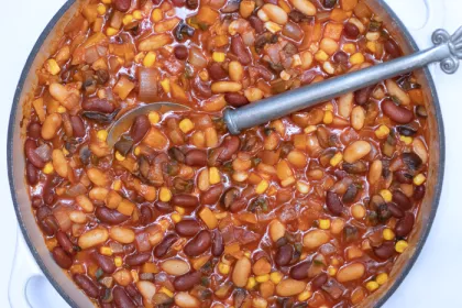 large pot with multi bean chili and a large silver spoon