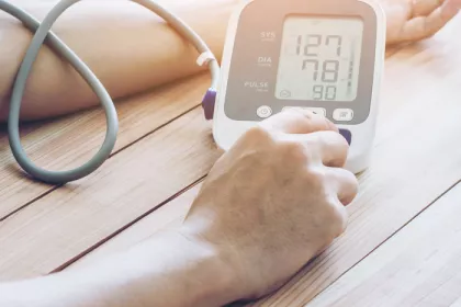 a person using an at home bp monitor