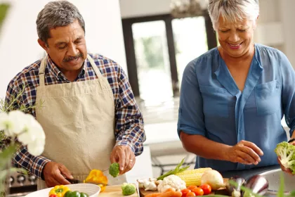 a man and a woman chopping vegetables