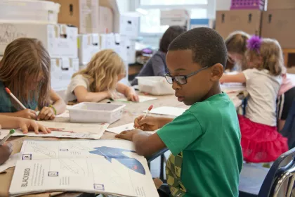A group of young students focusing on their work.