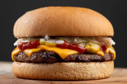 Classic burger with cheese, onions, pickle, mustard, and ketchup