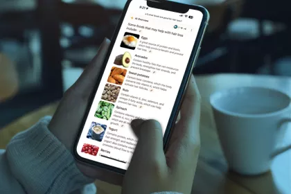 person scrolling on a smart phone in a coffee shop