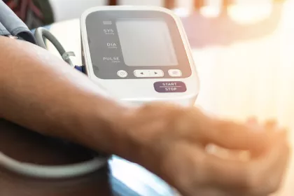 person using at at-home blood pressure monitor