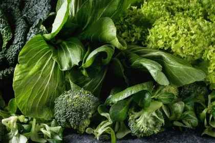 Seasonal produce - a closeup of broccoli, spinach, kale, and other leafy greens in season in December