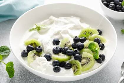 bowl of yogurt with blue berries and kiwis