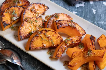 white plate holding slices of cooked butternut squash