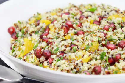 bowl of quinoa, with other chopped vegetables and herbs and pomegranate seeds