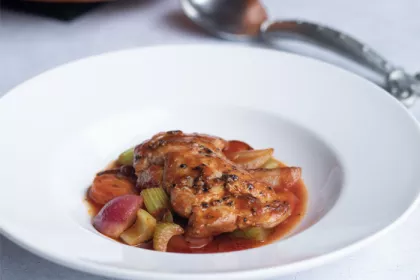 large white bowl with chicken a sauce