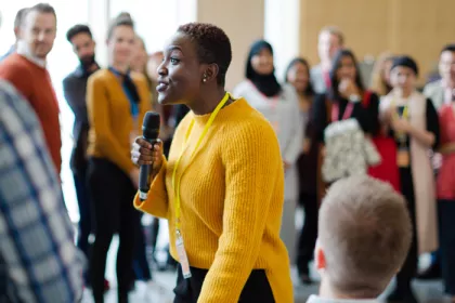 A woman speaking to a diverse group