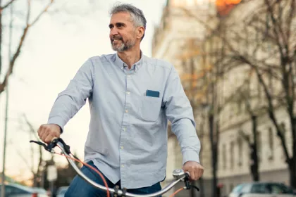 man on a bike riding through a city
