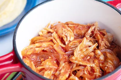 red pot full of pulled chicken 