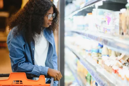 Person looking at yogurt on store 
