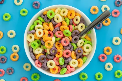 Colored breakfast cereal in a bowl on a blue background
