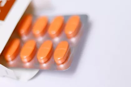 A blister pack of red oblong pills