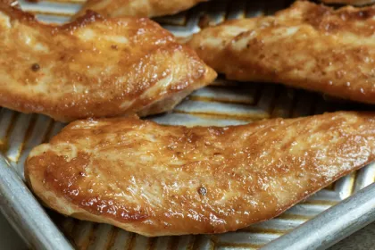 metal sheet pan with breaded chicken on it