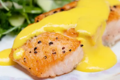salmon filet with a yellow mango sauce on top