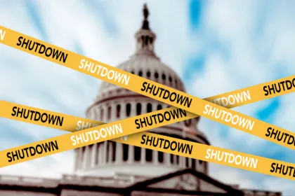 The U.S. Capitol dome behind caution tape with the word SHUTDOWN on it