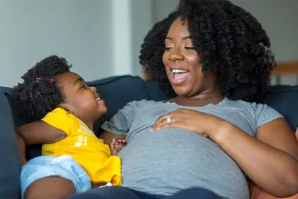 a pregnant mother and her daughter