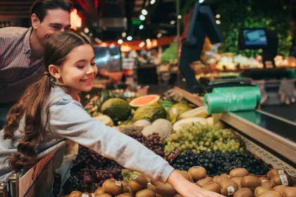 A father and daughter grocery shopping