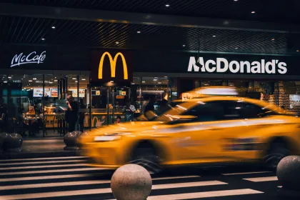 A New York City cab passing a McDonald's at night
