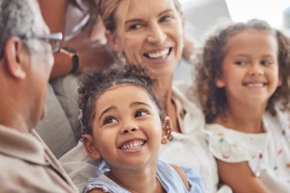3 generations of women smiling at each other