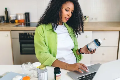 A woman researching supplements on her laptop