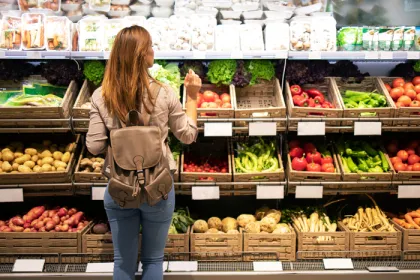 woman in produce section of grocery store