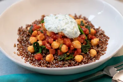 white bowl with chickpea sew topped with yourt