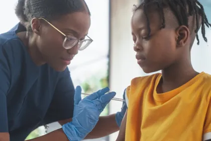 doctor giving child a vaccine in arm