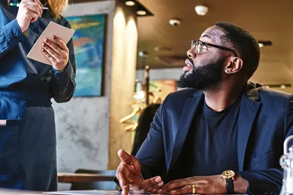 Person reading menu at a restaurant