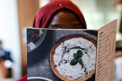 A woman reading a menu.